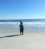 child standing on beach